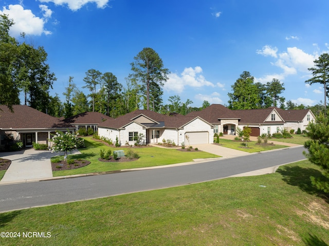 ranch-style house featuring a garage and a front lawn