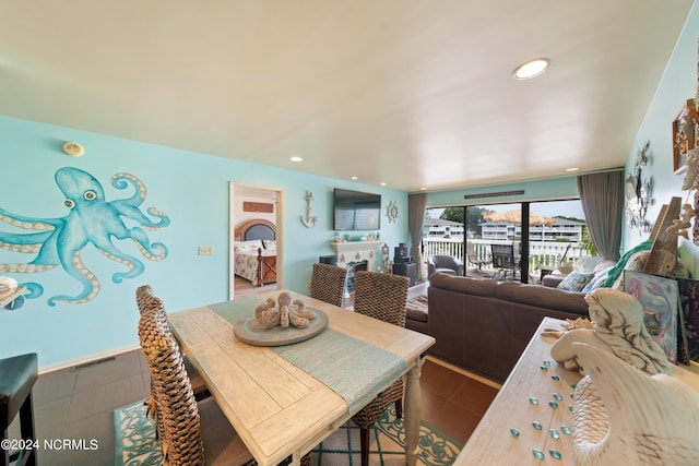 dining room featuring tile patterned flooring, a fireplace, visible vents, and recessed lighting