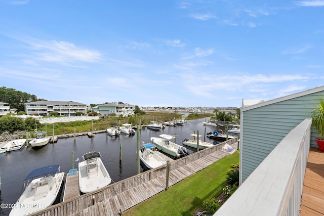 dock area with a water view and a yard