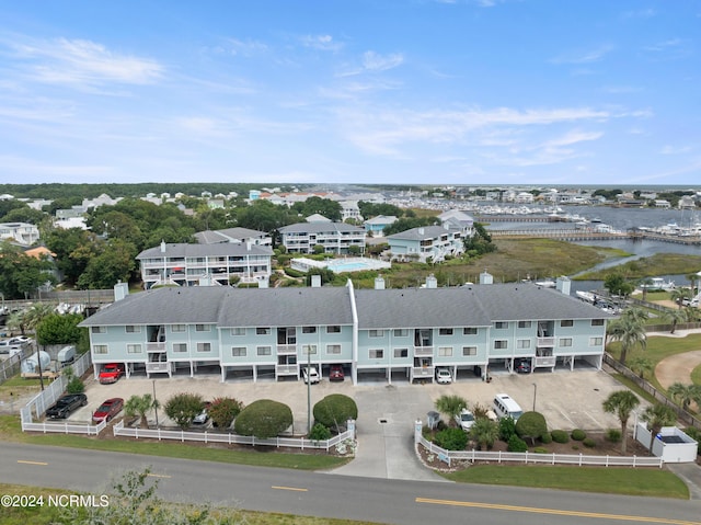 drone / aerial view featuring a water view and a residential view