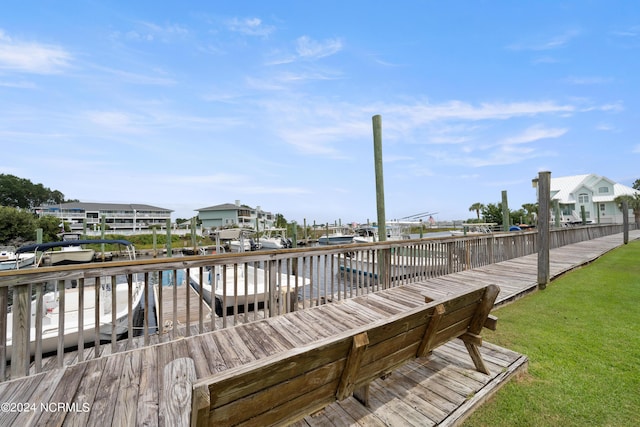 dock area with a water view and a lawn