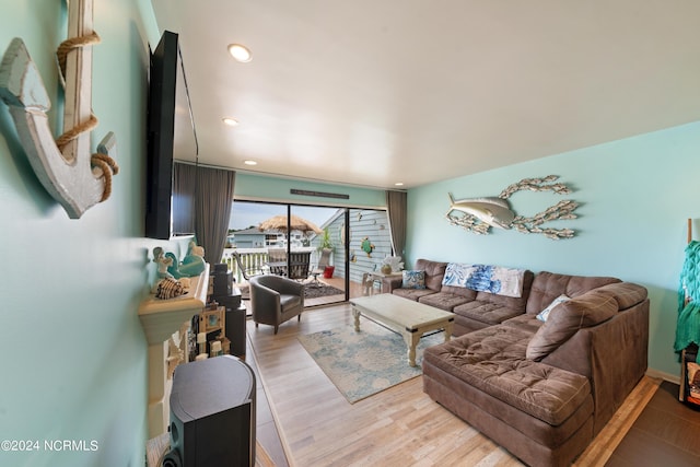 living area with light wood finished floors and recessed lighting