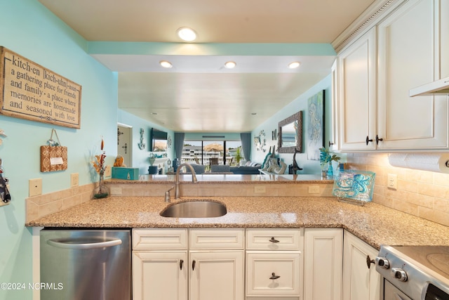 kitchen featuring light stone counters, stove, a sink, stainless steel dishwasher, and decorative backsplash