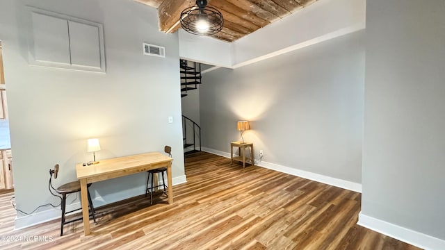 interior space featuring wood finished floors, visible vents, and baseboards