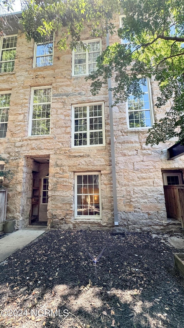 exterior space featuring stone siding