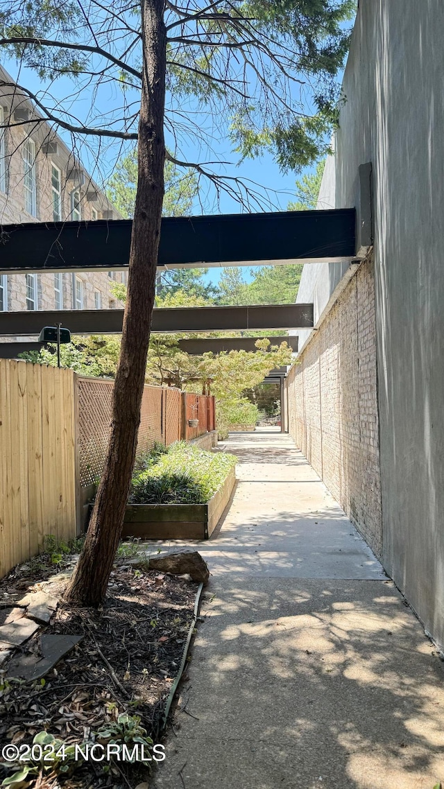 exterior space with brick siding and fence