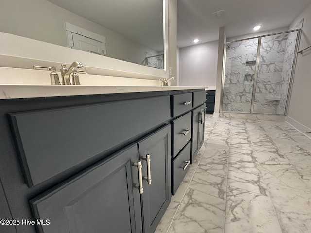 bathroom featuring an enclosed shower and vanity