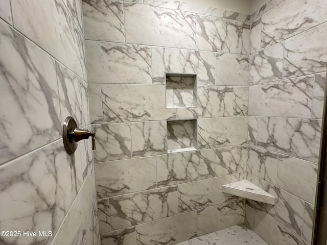 bathroom with a tile shower