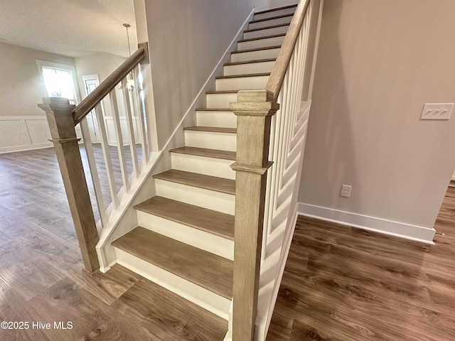 stairs featuring hardwood / wood-style floors