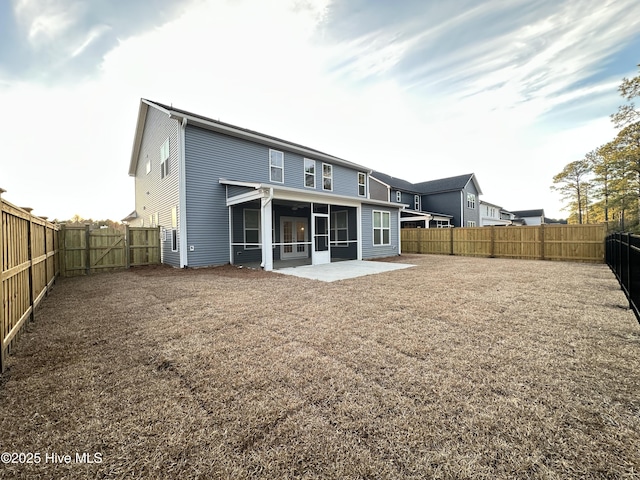 back of house with a sunroom and a patio area