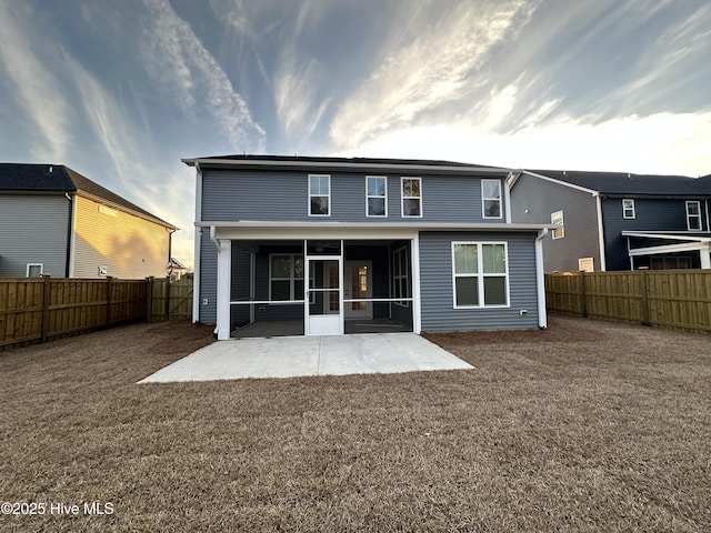 rear view of property featuring a patio area and a sunroom