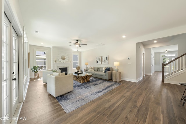 living room with ceiling fan, dark hardwood / wood-style flooring, and a wealth of natural light