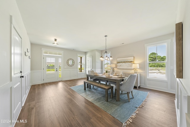 dining area featuring dark hardwood / wood-style flooring and a chandelier