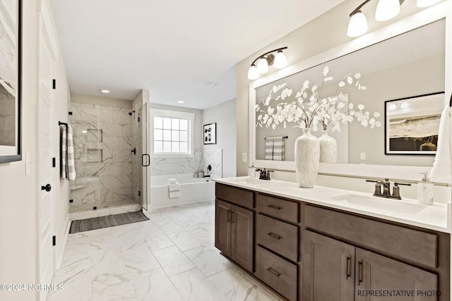 bathroom featuring separate shower and tub and vanity