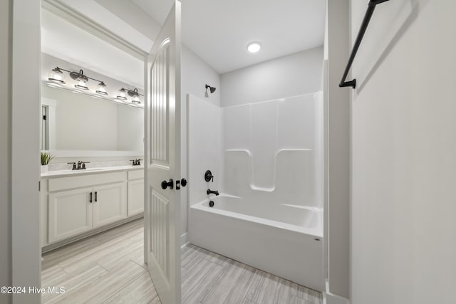 bathroom featuring vanity and shower / tub combination