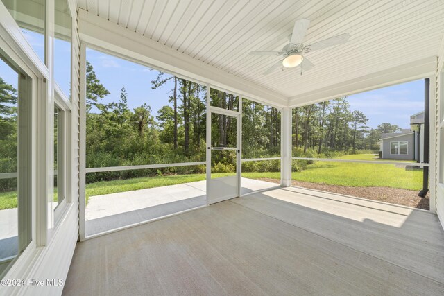 unfurnished sunroom with ceiling fan