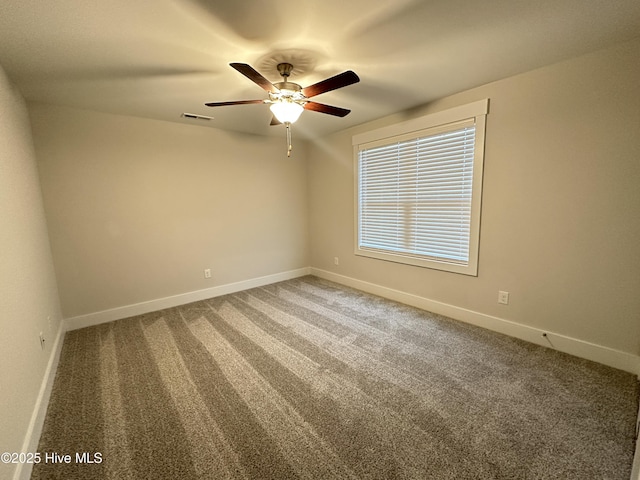 carpeted spare room with ceiling fan