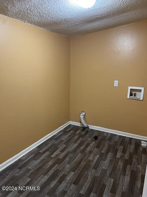 laundry room with hookup for a washing machine, dark wood-type flooring, and a textured ceiling