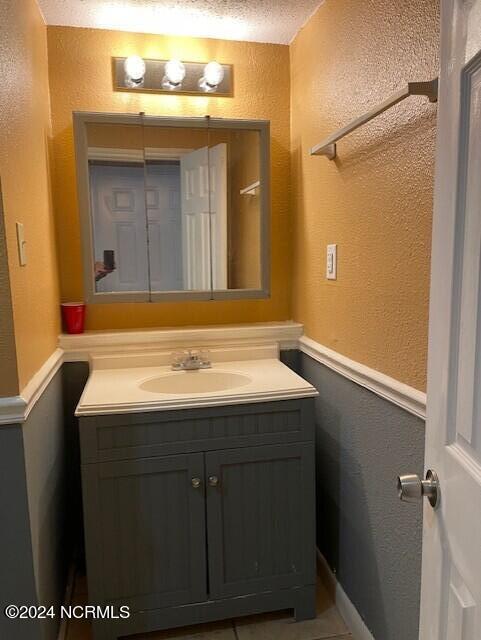 bathroom featuring vanity and a textured ceiling