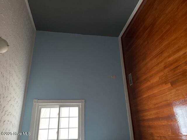 unfurnished room with wood walls