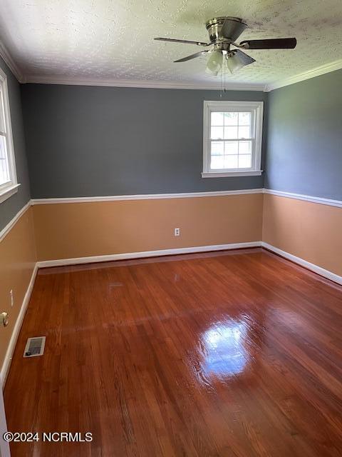 unfurnished room featuring crown molding, ceiling fan, hardwood / wood-style floors, and a textured ceiling