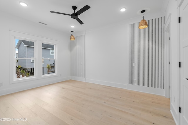 unfurnished room featuring a ceiling fan, visible vents, light wood-style flooring, recessed lighting, and crown molding