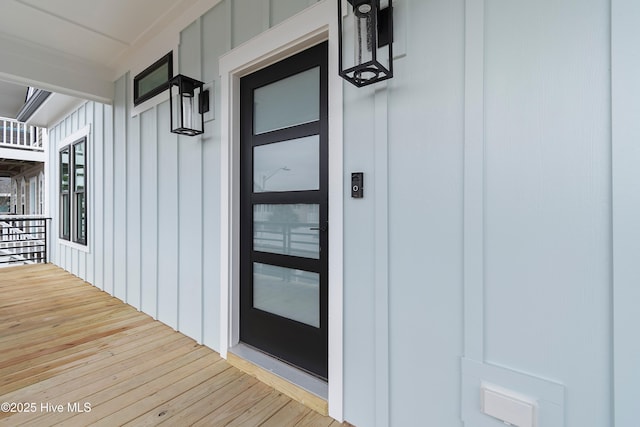 property entrance featuring board and batten siding