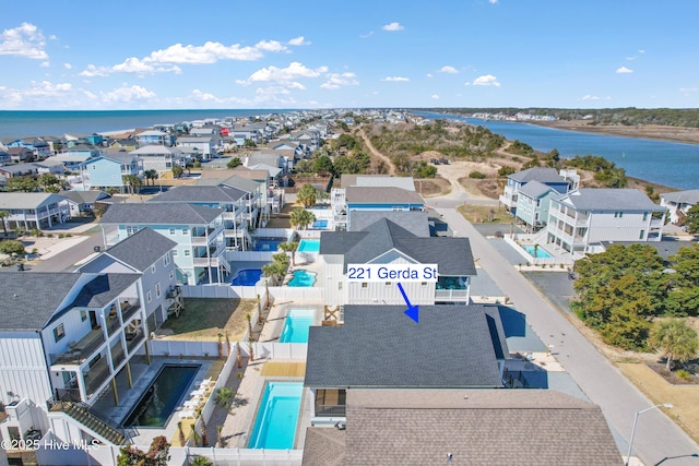 drone / aerial view with a residential view and a water view