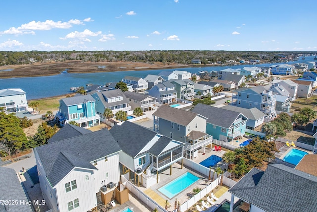 birds eye view of property with a residential view and a water view