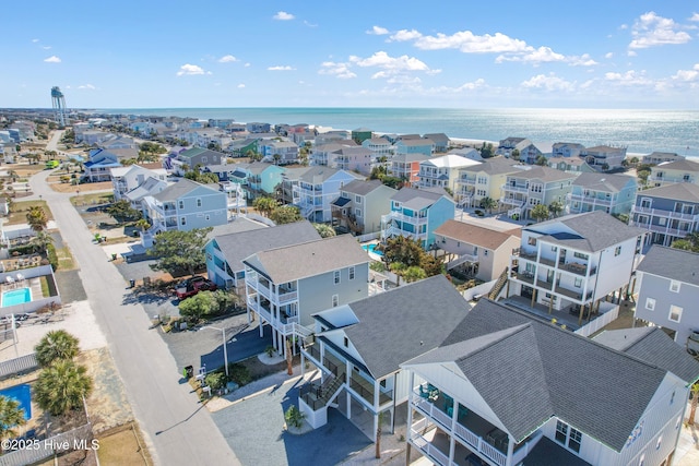 drone / aerial view featuring a residential view and a water view