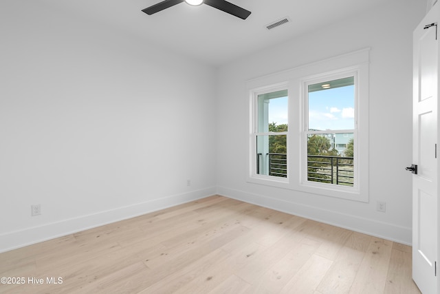 unfurnished room with visible vents, light wood-style flooring, a ceiling fan, and baseboards