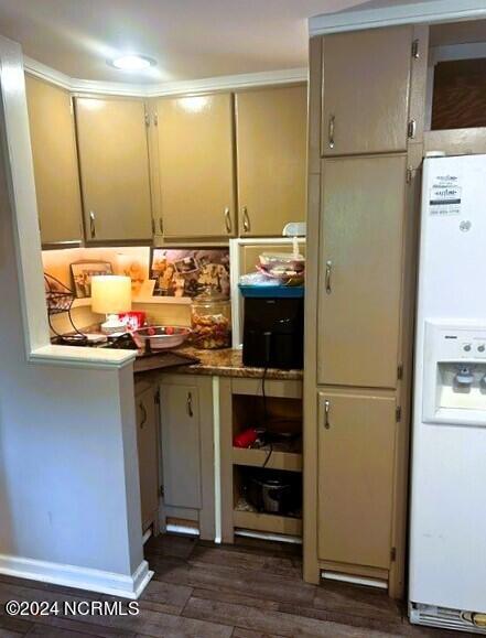 kitchen featuring dark hardwood / wood-style floors and white fridge with ice dispenser