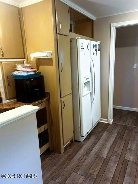 kitchen with white fridge with ice dispenser, crown molding, and dark hardwood / wood-style floors