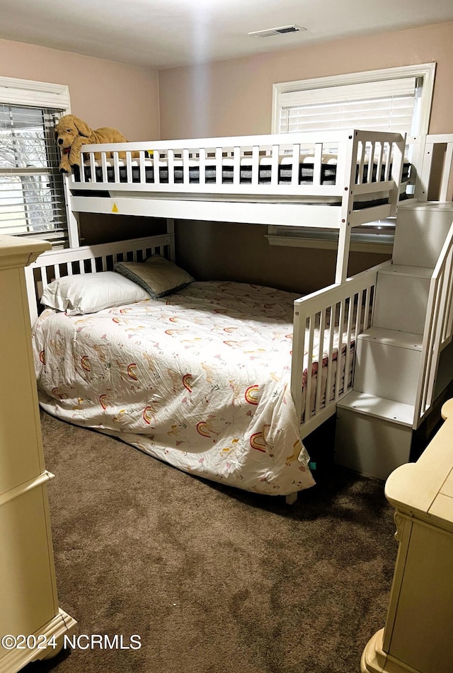 bedroom with dark carpet