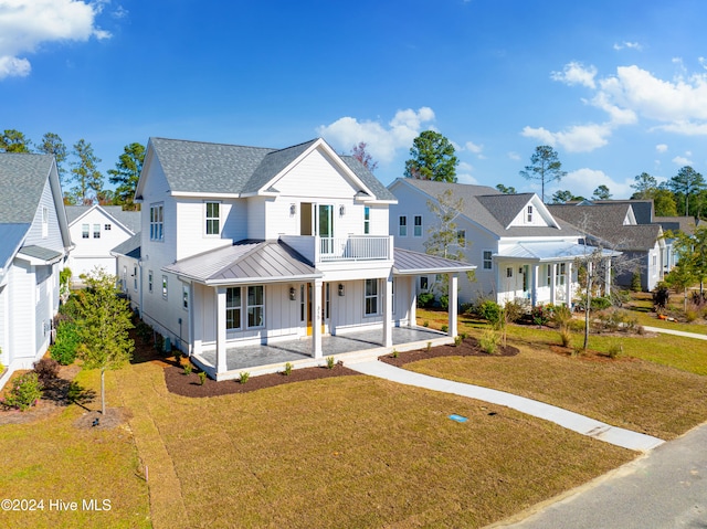 view of front of house featuring board and batten siding, ceiling fan, a balcony, and a porch