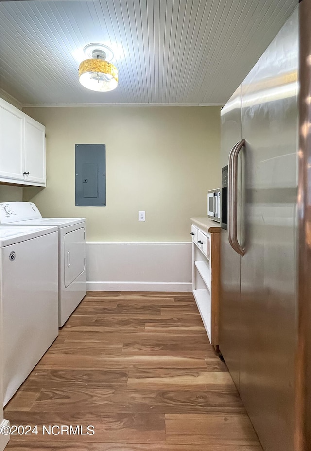 clothes washing area featuring cabinet space, light wood finished floors, electric panel, wood ceiling, and washing machine and dryer