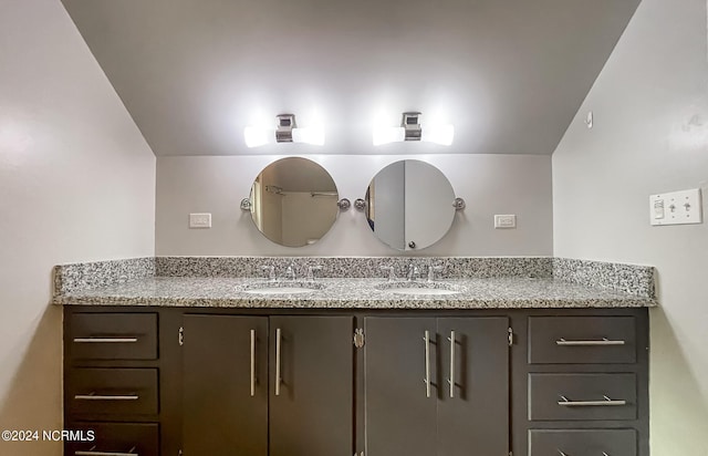 bathroom featuring double vanity and a sink