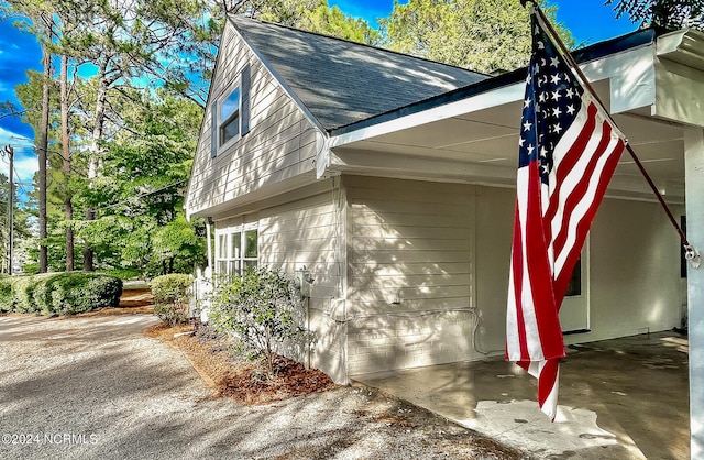 view of side of property with a shingled roof