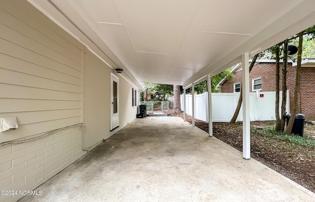 view of patio / terrace featuring an attached carport and fence