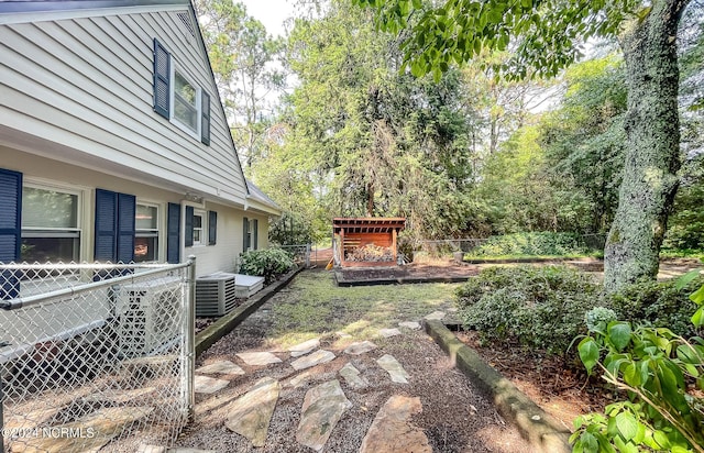 view of yard featuring cooling unit and fence