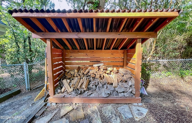 wooden deck featuring fence and an outdoor structure