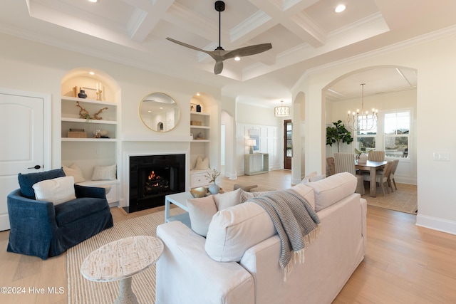 living room featuring crown molding, ceiling fan with notable chandelier, coffered ceiling, and light wood-type flooring