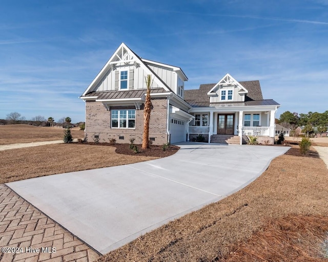 craftsman inspired home featuring covered porch and a garage