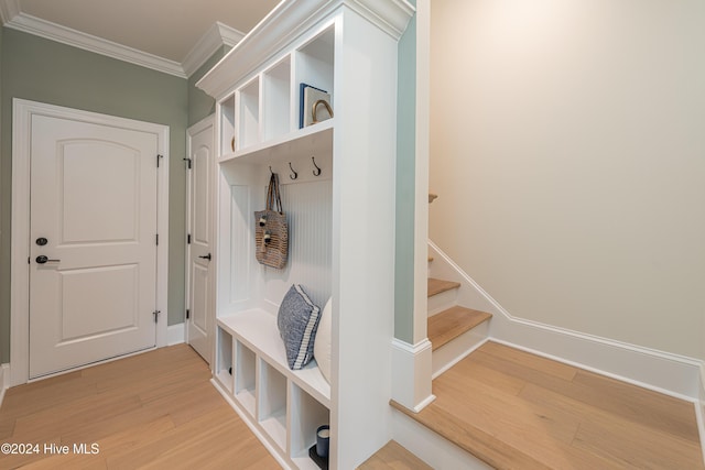 mudroom featuring hardwood / wood-style flooring and ornamental molding