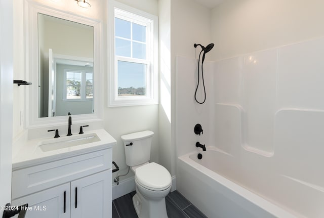 full bathroom featuring shower / bathing tub combination, vanity, a healthy amount of sunlight, and toilet