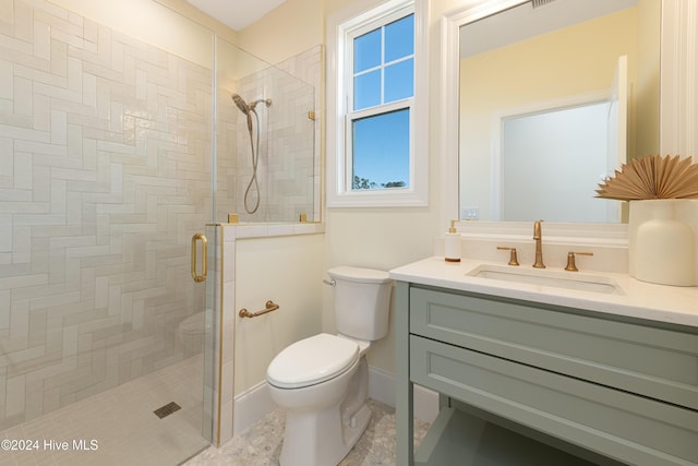 bathroom featuring tile patterned floors, vanity, toilet, and walk in shower