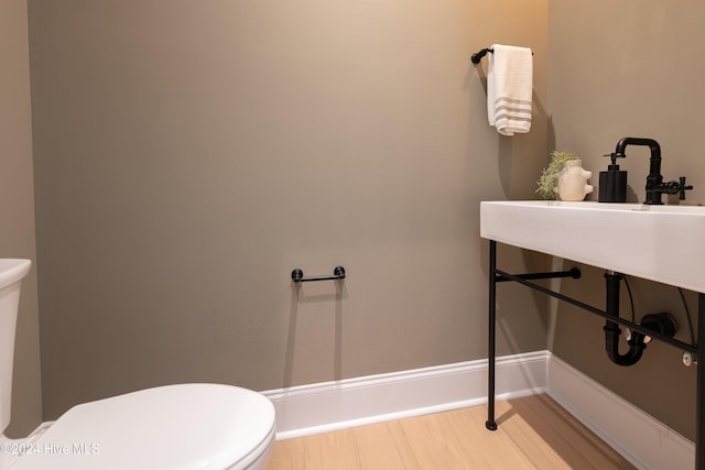 bathroom featuring hardwood / wood-style floors and toilet