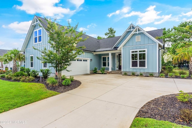 view of front facade featuring an attached garage, a shingled roof, concrete driveway, a front lawn, and board and batten siding