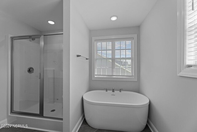 bathroom featuring tile patterned flooring and independent shower and bath