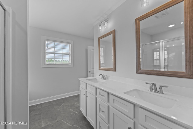 bathroom with walk in shower and vanity